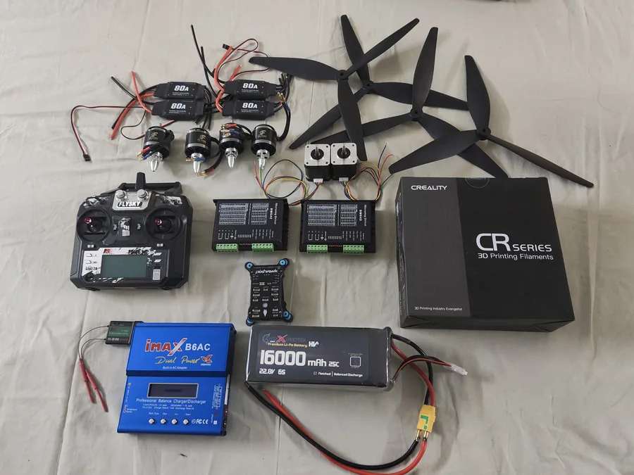 The procured components laid out: brushless motors, ESCs, stepper drivers, transmitter, 16000 mAh battery, charger, propellers and printing filament